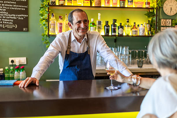 istock Bartender serving wine to customer in restaurant 2234829755