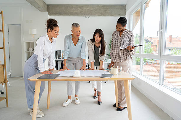 istock Professional women collaborating in a modern office setting with bright windows 2234830735