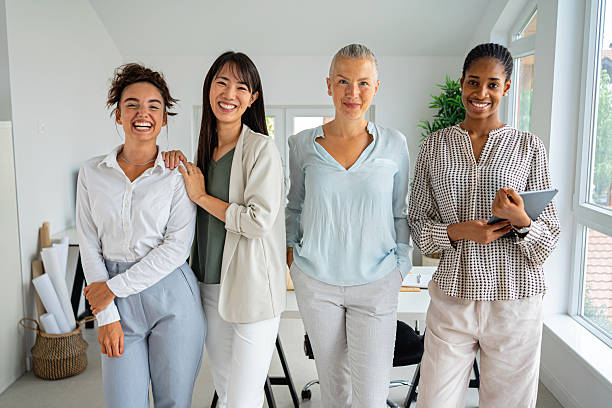 istock Four businesswomen smiling together in a bright office environment 2234831464