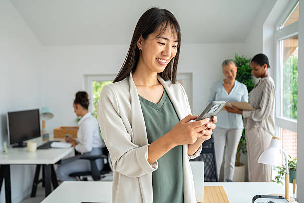 istock Businesswoman Working in a Bright Office with Colleagues Discussing Work 2234831792