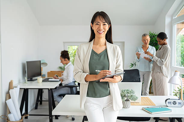 istock Group of professionals collaborating in a modern, bright office environment 2234831928