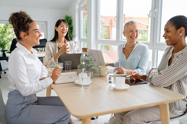 istock Group of four women collaborating in a bright modern office environment 2234832425