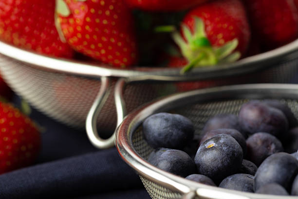 Fresh ripe strawberry and blueberry in bowl close up
