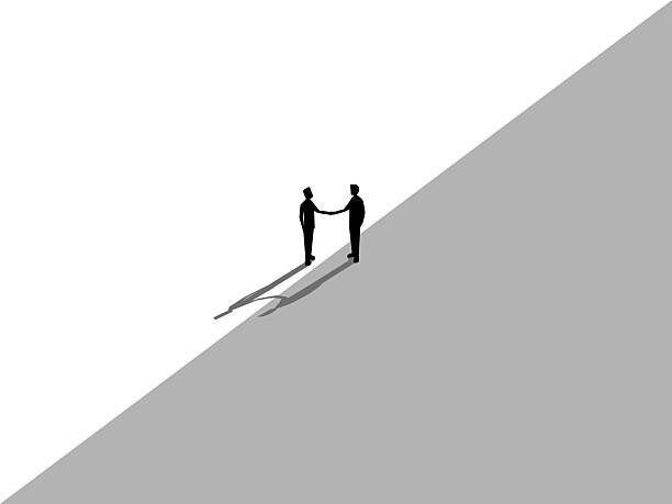 istock Two businessmen stand and shake hands and agree on different business deals 2234835411