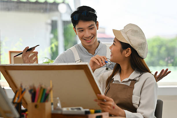 istock An Asian Artistic couple enjoying their time in a studio, exchanging ideas while painting side by side 2234835513