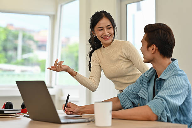 istock A professional team having a friendly conversation while working on a laptop in an office, showing collaboration and teamwork 2234835686