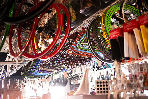 Senior Asian entrepreneur discussion about  custom-made bicycle with customer on smartphone.