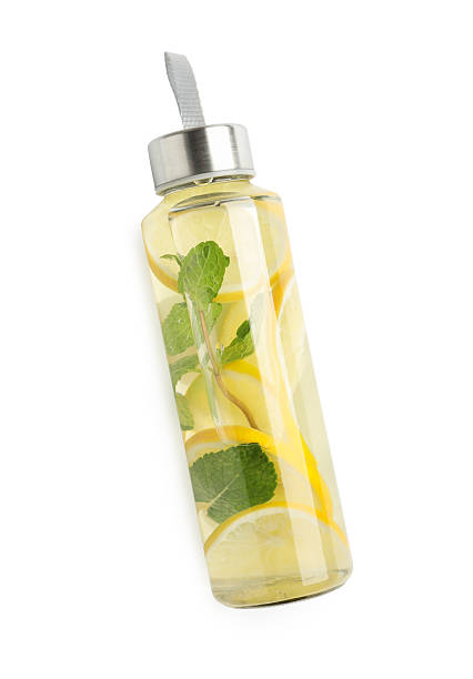 istock Lemon water with mint in bottle isolated on white, top view 2234838236