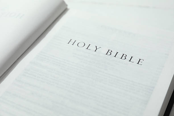 istock Open Holy Bible in English language on table, closeup 2234839292