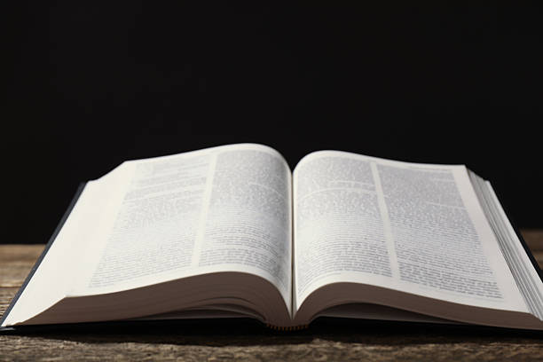 istock Open Holy Bible in English language on wooden table, closeup. Space for text 2234839317
