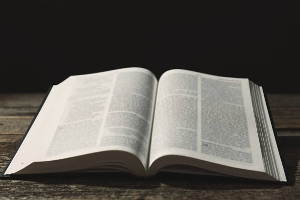 istock Open Holy Bible in English language on wooden table 2234839368