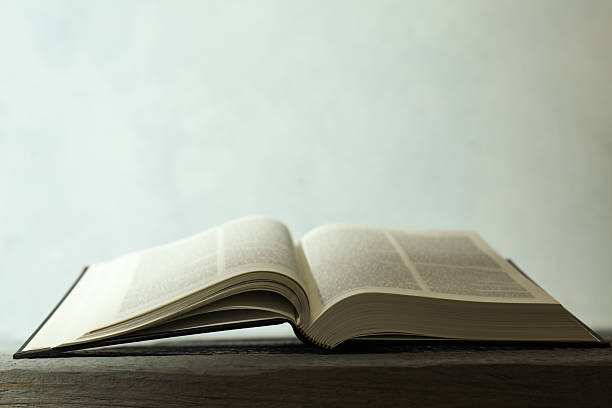 istock Open Holy Bible in English language on wooden table. Space for text 2234839372