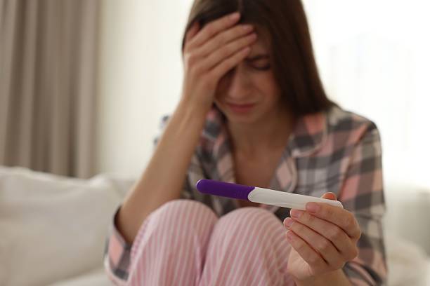istock Woman with negative pregnancy test at home, selective focus 2234840663