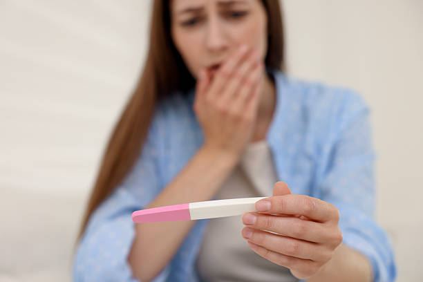 istock Upset woman with negative pregnancy test at home, selective focus 2234840803
