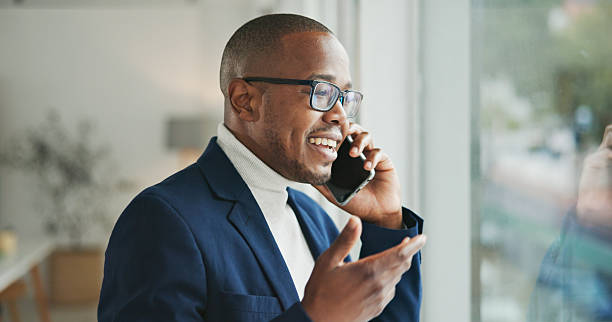 istock Smiling Professional Talking on Phone Near Window in Bright Office Setting 2234841219