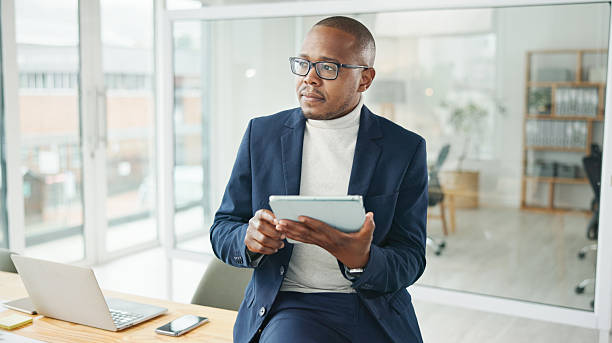 istock Professional Businessman Contemplating While Using a Tablet in a Modern Office 2234841226