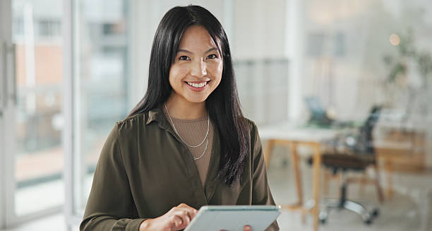 istock Confident Businesswoman Using a Tablet in a Bright Modern Office Space 2234841254