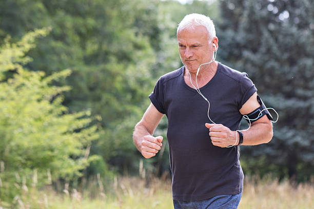 istock Man jogging outdoors with headphones and smartwatch 2234843305