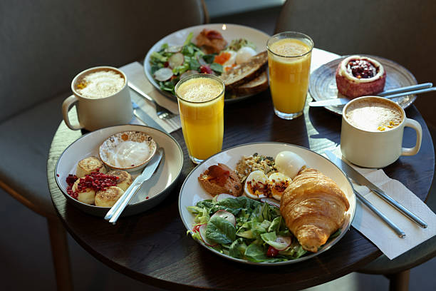 istock Tasty breakfast. Different meals and drinks served on wooden table in cafe 2234843612