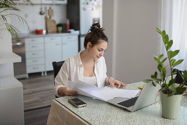 istock Female Professional Studying Budget And Expense Documents At Home With Focused Expression 2234844625