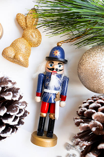 istock Festive nutcracker ornament with glittering decorations and pinecones in holiday setting 2234850088