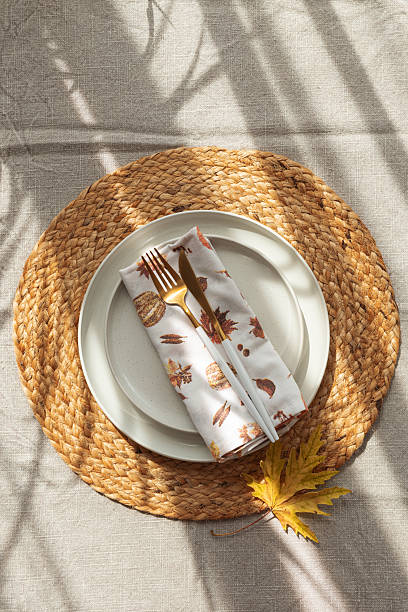 istock Table Setting with Yellow Leaves on White Plate and Woven Placemat under Sun Light 2234853117