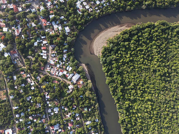 River turn next to town and jungle above top drone view