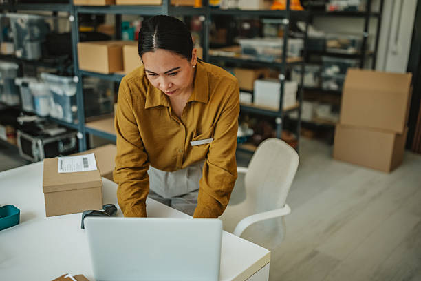 istock Asian woman managing logistics in a busy warehouse while preparing orders and overseeing operations 2234856566
