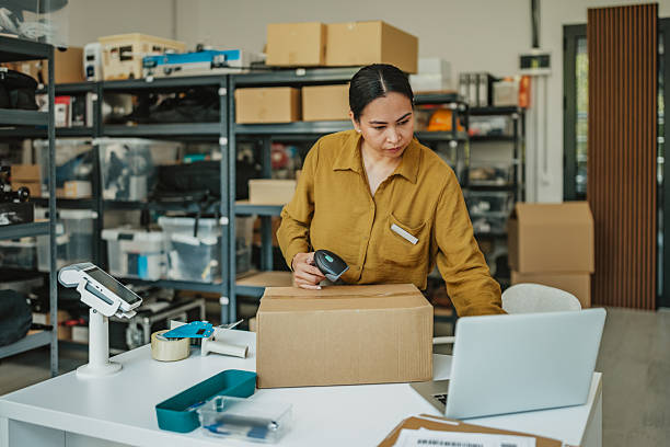 istock Asian woman managing orders and packaging in a modern warehouse environment 2234856779
