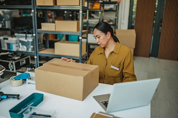 istock Asian woman managing packaging and order fulfillment in a busy warehouse setting 2234856810