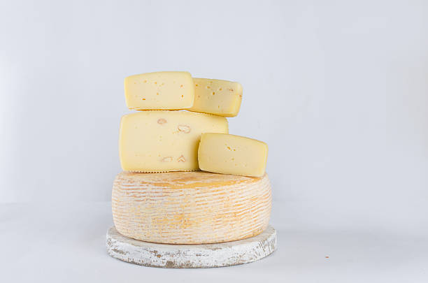 istock cheese heads of different kinds stacked on table 2234860244