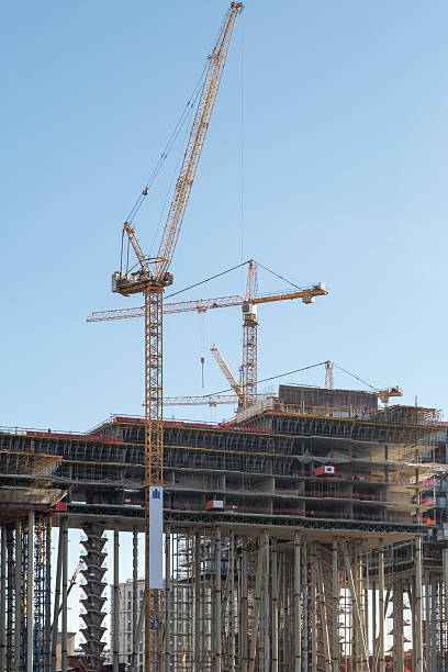 istock Construction of a High-Rise Building With Cranes at Work During Clear Daylight 2234861407