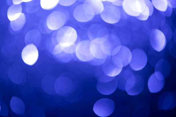 This defocused abstract background presents shimmering blue bokeh circles, frozen textures, and glowing sparkle. The soft focus shine adds elegance and cold romance, ideal for winter-themed celebrations, Christmas cards, New Year's Eve promotions, or party - social event visuals. Designed with glitter, light bursts, and copy space for use in web banners, wallpaper - decor, and seasonal slide shows.