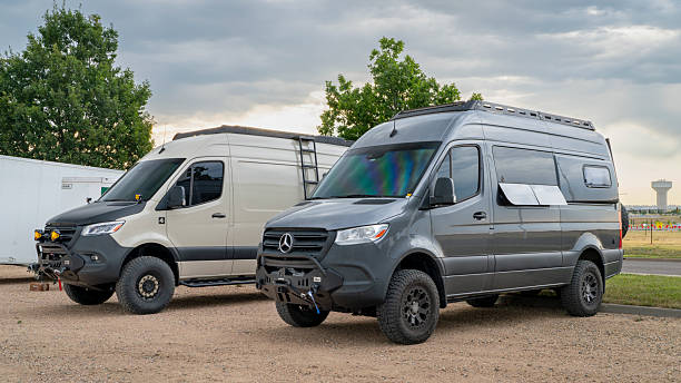Loveland, CO, USA - August 22, 2025: Two 4x4 camper vans built on Mercedes Sprinter chassis.