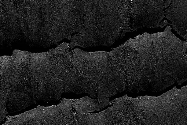 istock Pitch-black grain erupts around a single circular scar, etched by intense heat. 2234863851