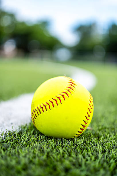istock A vibrant neon yellow softball rests directly on a thick, 2234868796