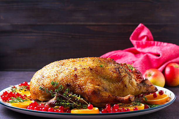 istock Roasted whole duck with fruits and berries 2234869615