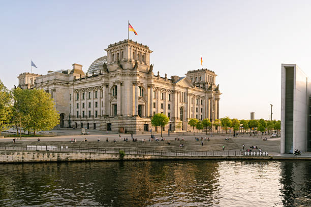 The majestic Reichstag building and its surroundings are beautifully framed by the Spree River in the capital city of Berlin, Germany, capturing a serene and historically significant moment.