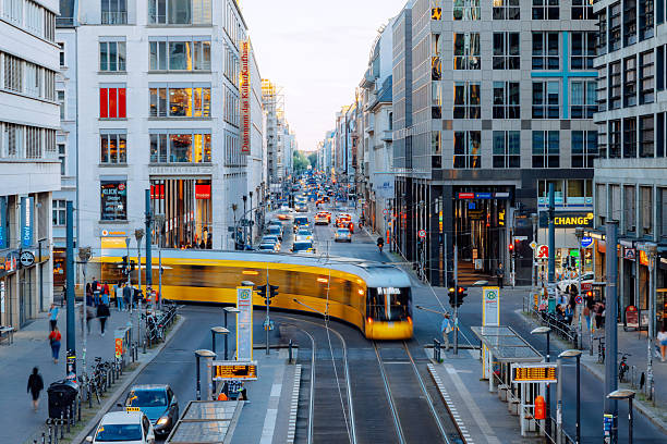 Bustling Friedrichstrasse in Berlin with pedestrians and passing trams.