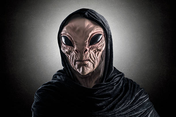 istock Mysterious humanoid alien at night over dark misty background 2234871014