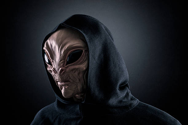 istock Mysterious humanoid alien at night over dark misty background 2234871680