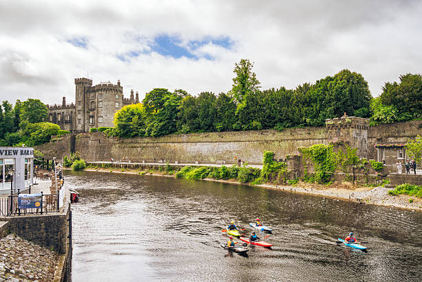 Kilkenny, Ireland - People Kayaking in the River Nore, downriver from Kilkenny Castle.