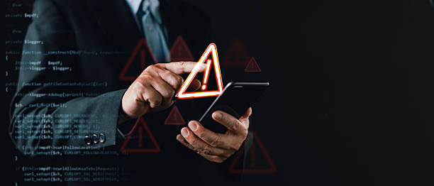 istock businessman in a suit uses a smartphone with floating warning icons and digital code overlay, symbolizing cybersecurity threats, system vulnerabilities, caution alerts, and digital risk awareness. 2234874867