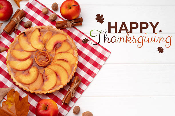 istock Festive peach pie displayed on a checkered tablecloth with autumn decor for Thanksgiving celebration 2234876559