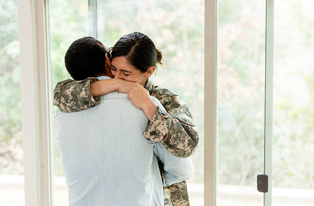 istock Emotional Reunion: Soldier in Uniform Embraces Loved One 2234876802