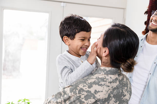 istock Happy family reunion: Soldier mom embraces son 2234876838
