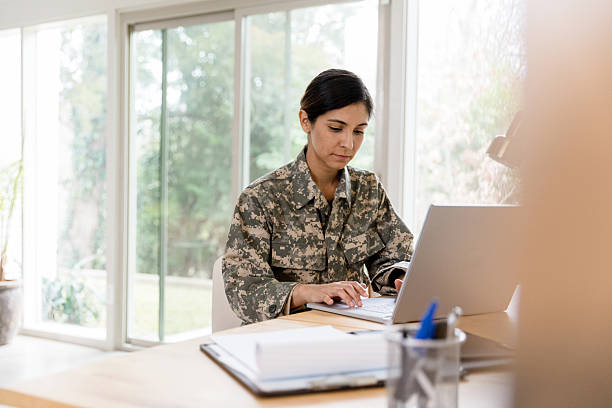istock Female Soldier Using Laptop, Working From Home Office 2234876847