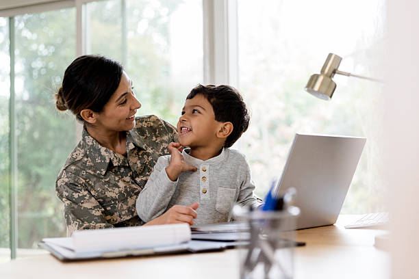 istock Happy Soldier Mom and Son Using Laptop at Home 2234876856
