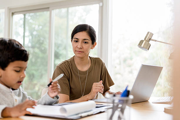istock Military Mom Assists Son with Homework Using Laptop 2234876860