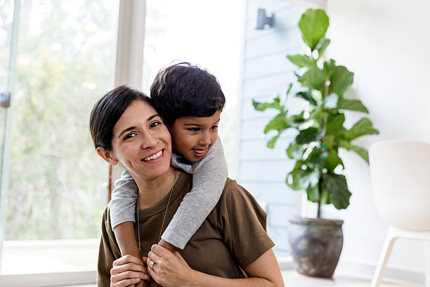 istock Happy Military Mom and Son Hugging Indoors 2234876884